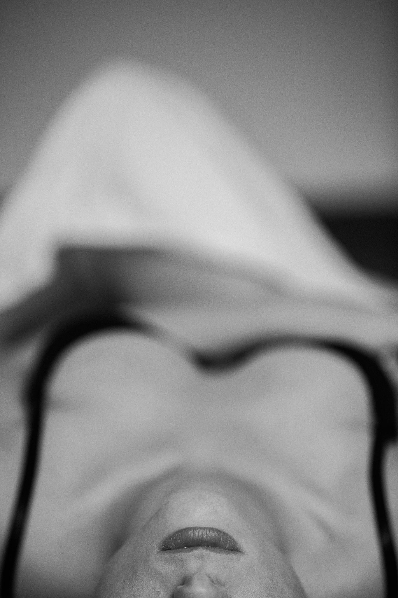 Dramatic close-up black and white portrait with shallow depth of field.