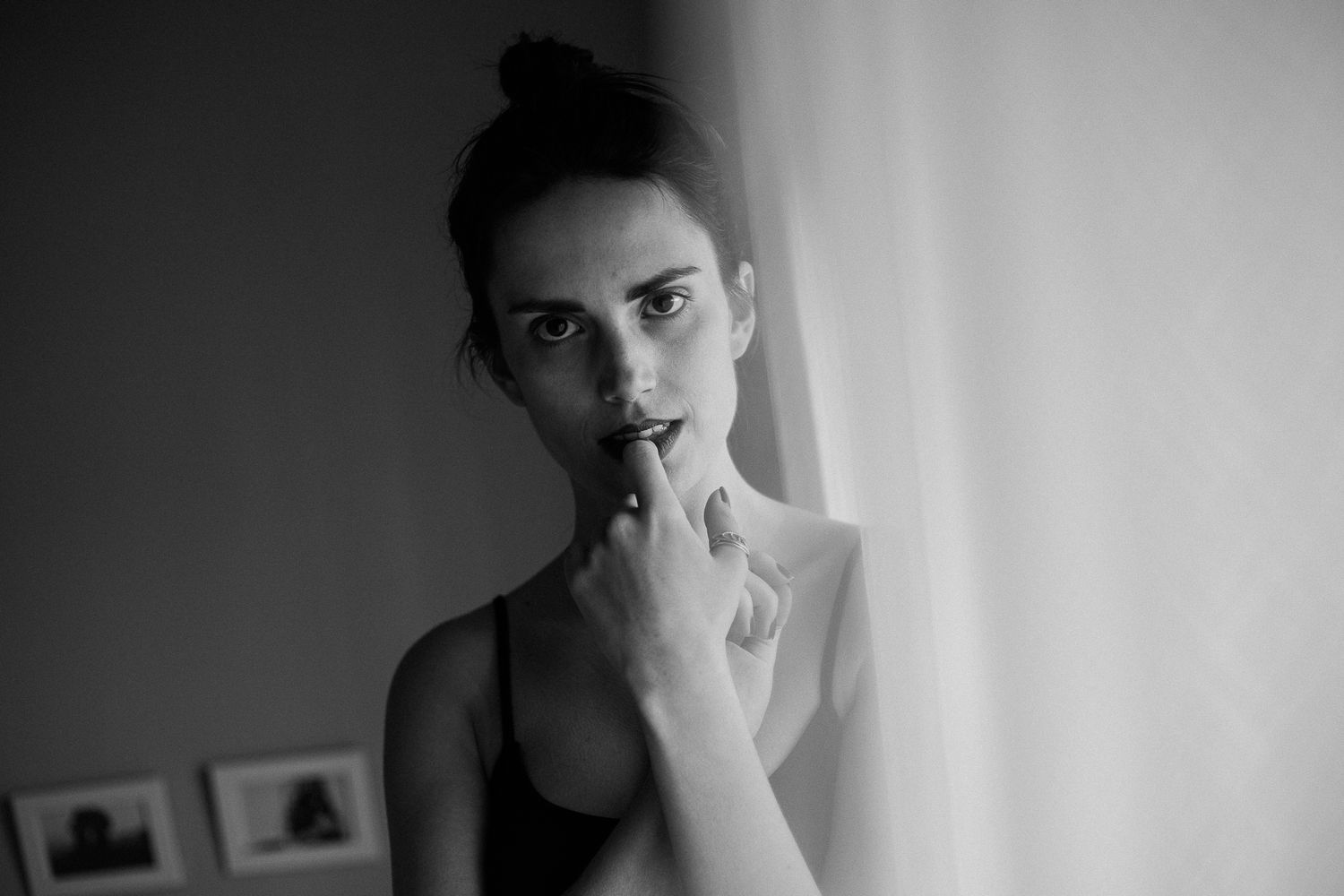 A series of black and white portrait photographs showing various moody and contemplative expressions.