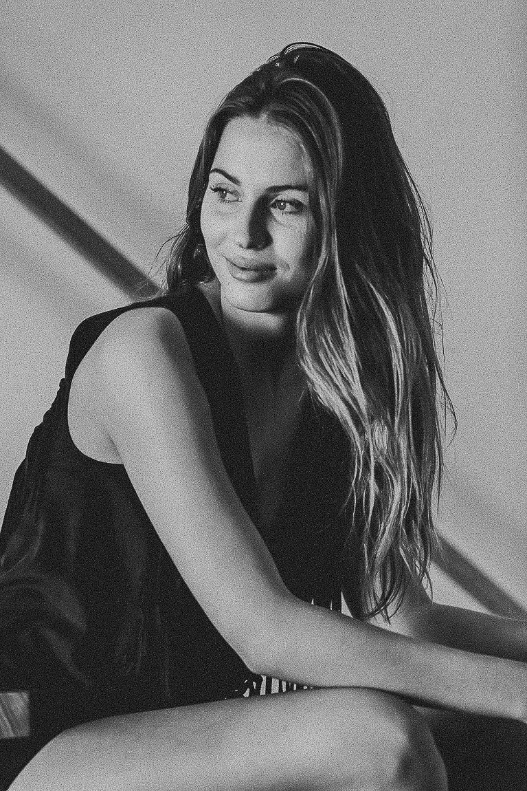Black and white artistic portrait series showing a model in dramatic poses against a minimalist background.