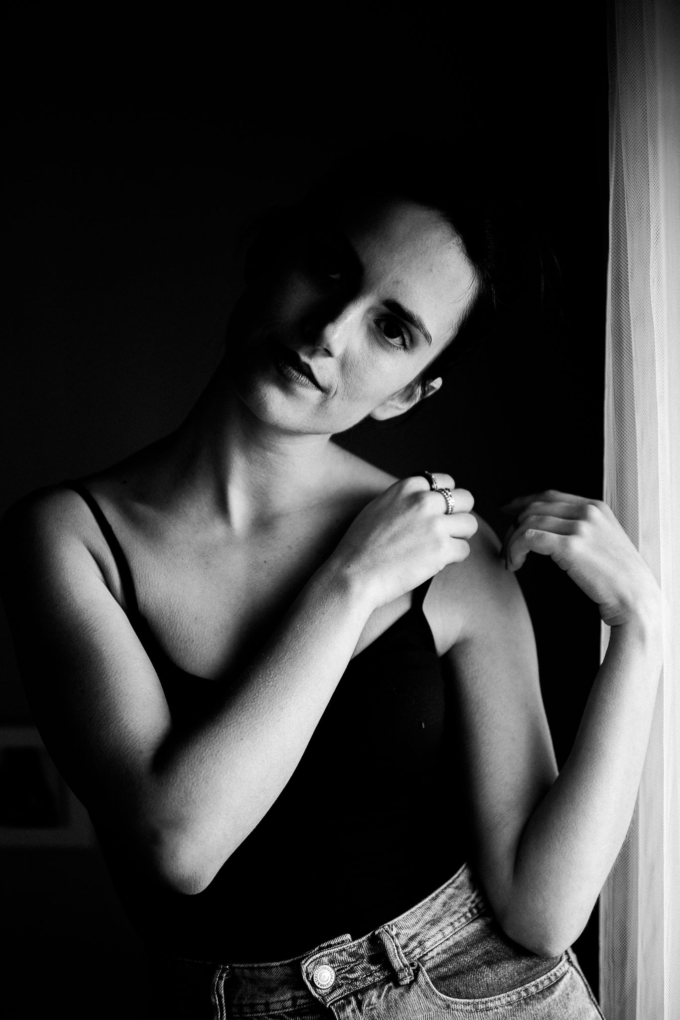 A dramatic black and white photo series showing intimate cropped portraits in moody lighting with artistic shadows.