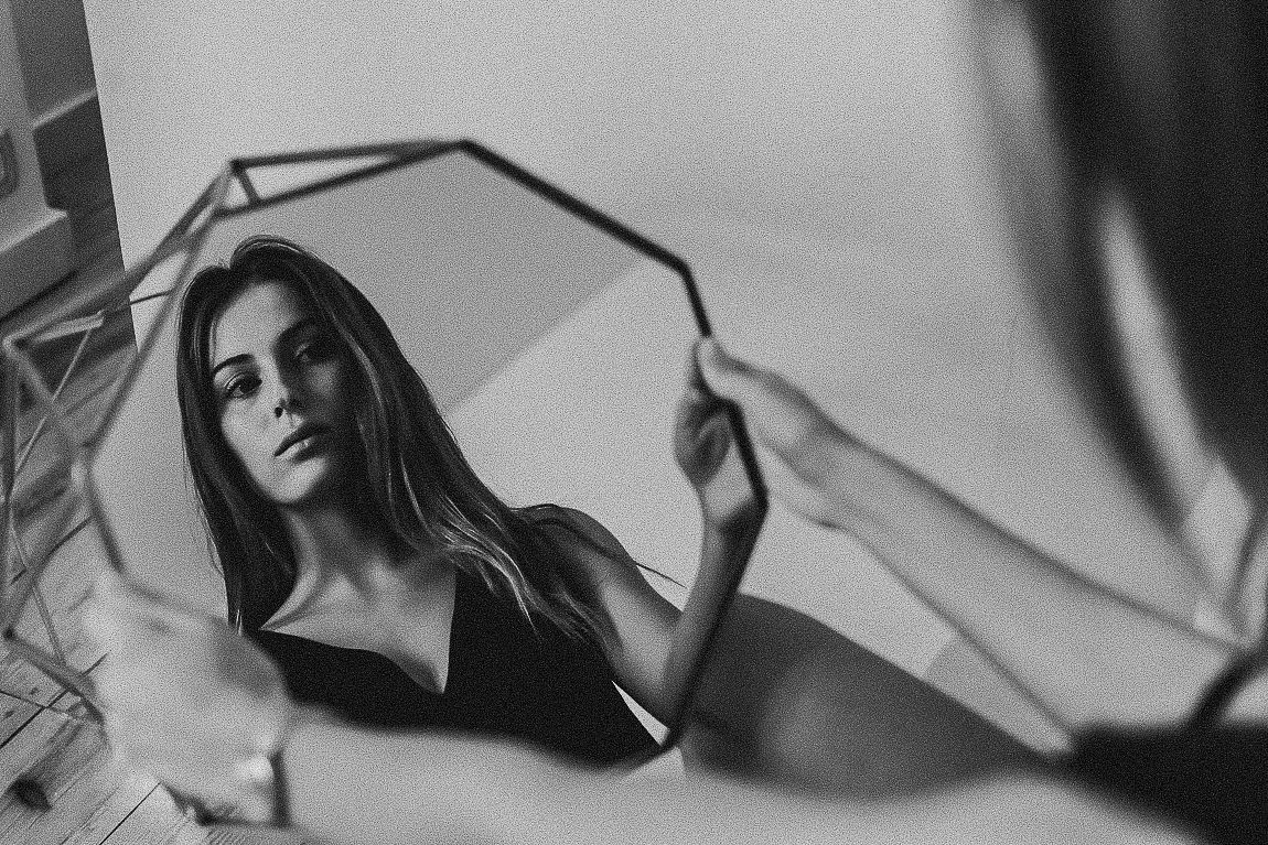 Black and white portrait series showing close-up artistic shots with dramatic shadows and lighting effects.