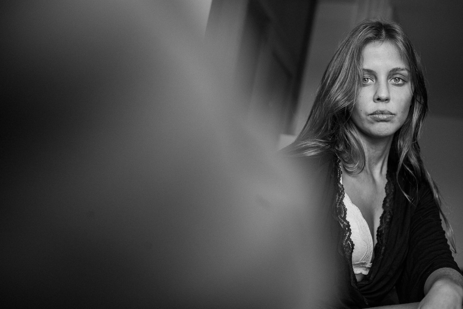 A series of black and white portrait photographs arranged in a horizontal row showing dramatic lighting and expressions.