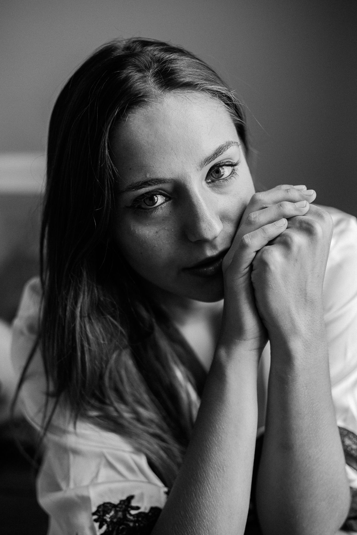 A black and white photo series showing a person in a white shirt posing with expressive emotions and hand gestures.