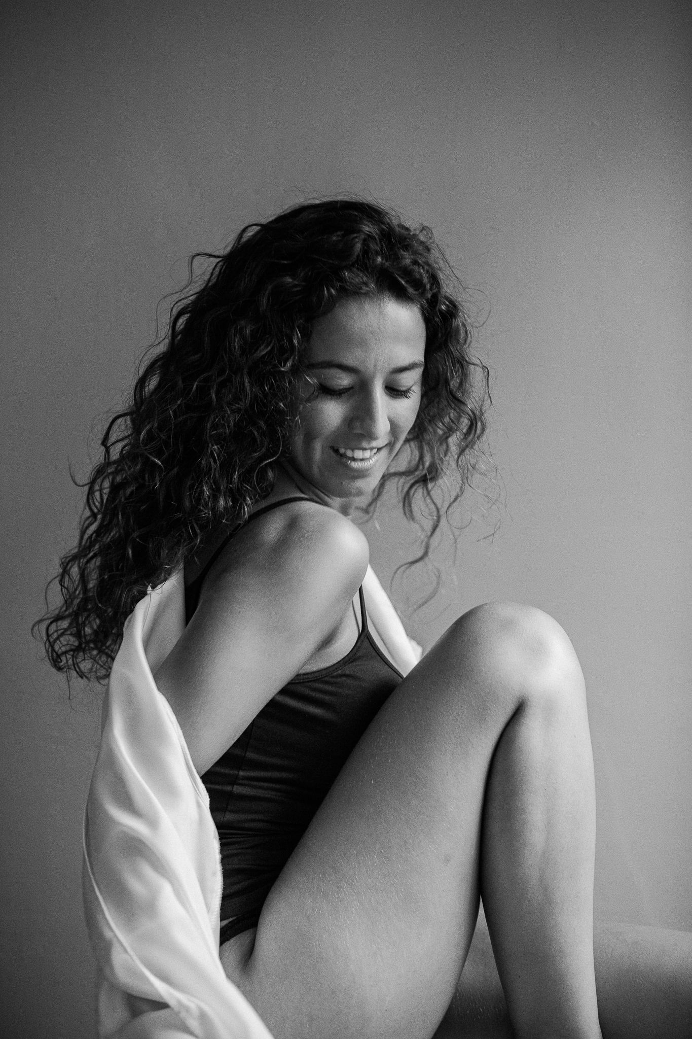 A series of black and white artistic photographs showing a person in contemplative poses against a simple background.