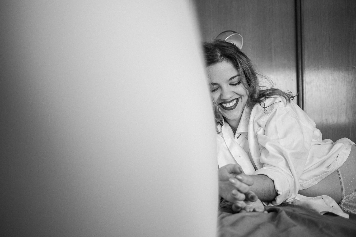 A black and white photo sequence showing someone lying in bed and stretching while waking up in the morning.