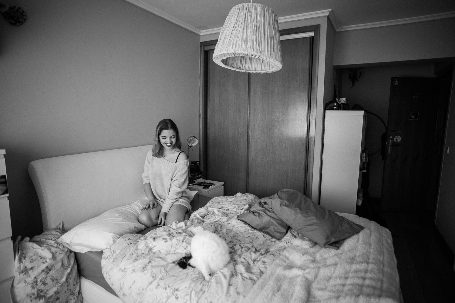Black and white photo series showing someone waking up and stretching in bed in the morning.