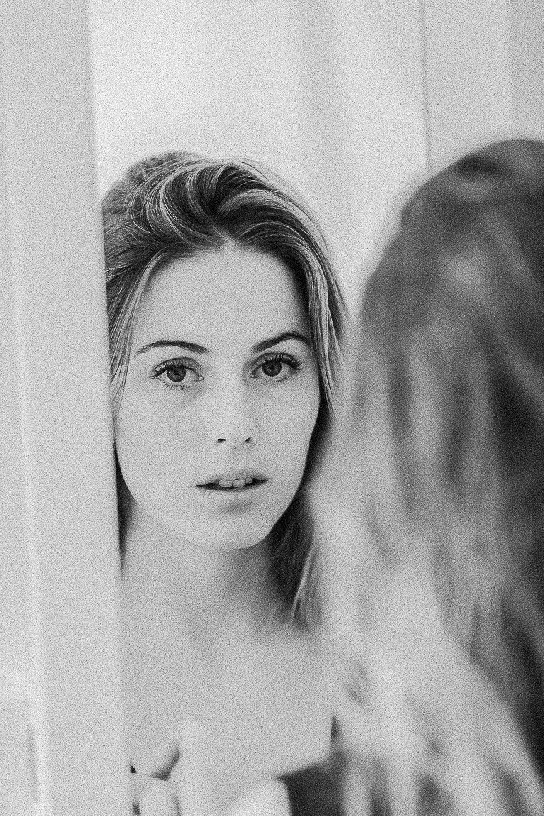 Black and white artistic portrait series showing soft focus closeup shots with dreamy lighting effects.