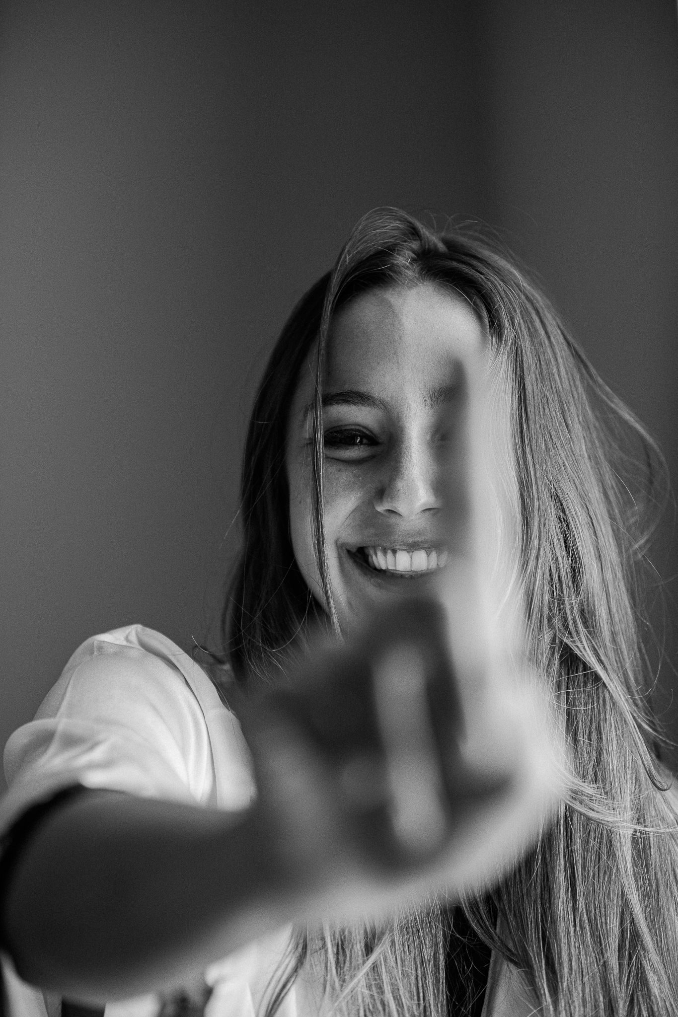 A black and white sequence of artistic portraits showing motion and blurred movements against a dark background.
