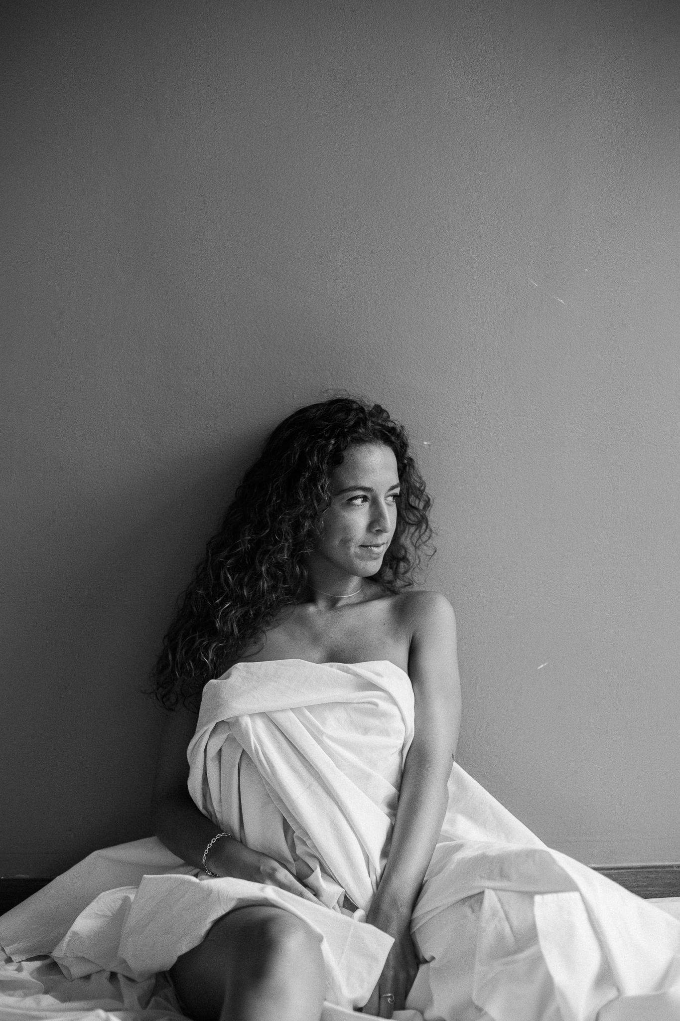 Black and white artistic portrait series with dramatic lighting and white fabric draping.
