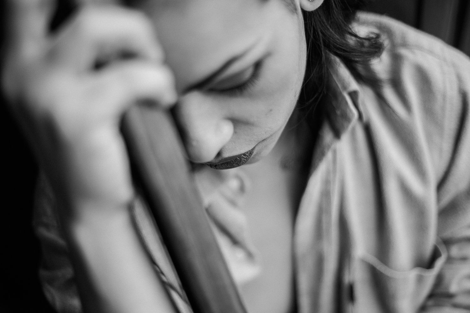 Black and white portrait series showing playful expressions and poses in an intimate setting.