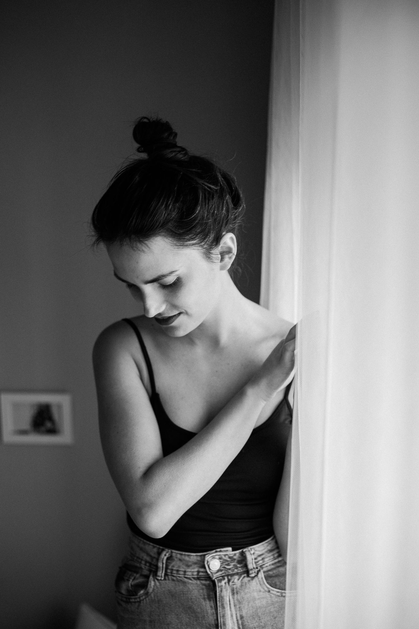 A black and white artistic portrait series showing a person in contemplative poses against a light background.