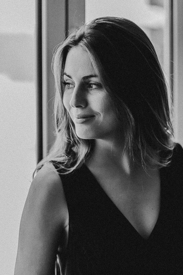 Black and white artistic portrait series showing graceful poses against window light in dramatic contrast.