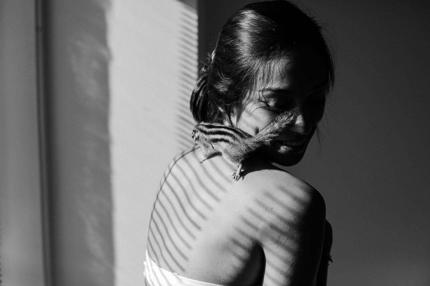Black and white portrait series showing person in dramatic shadows and diagonal lines creating moody composition.
