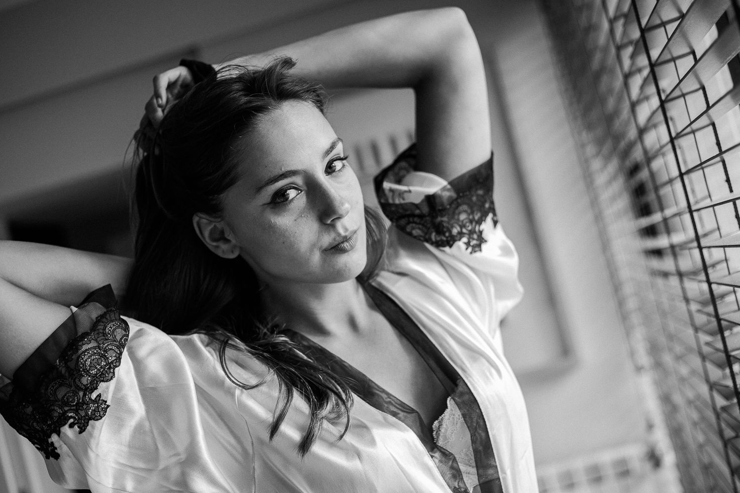 Black and white photo series showing a person in various dramatic poses against window light and shadows.