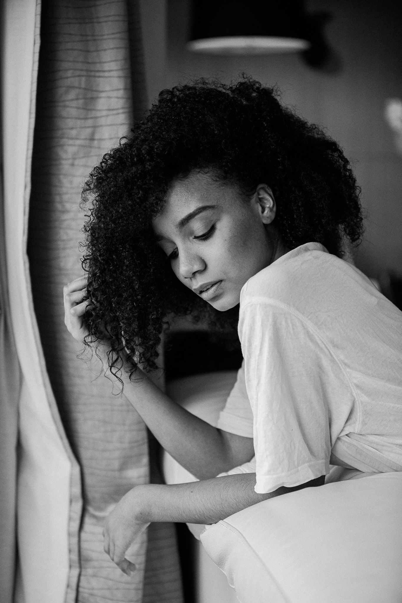 Artistic black and white photo series showing relaxed poses in natural window light.