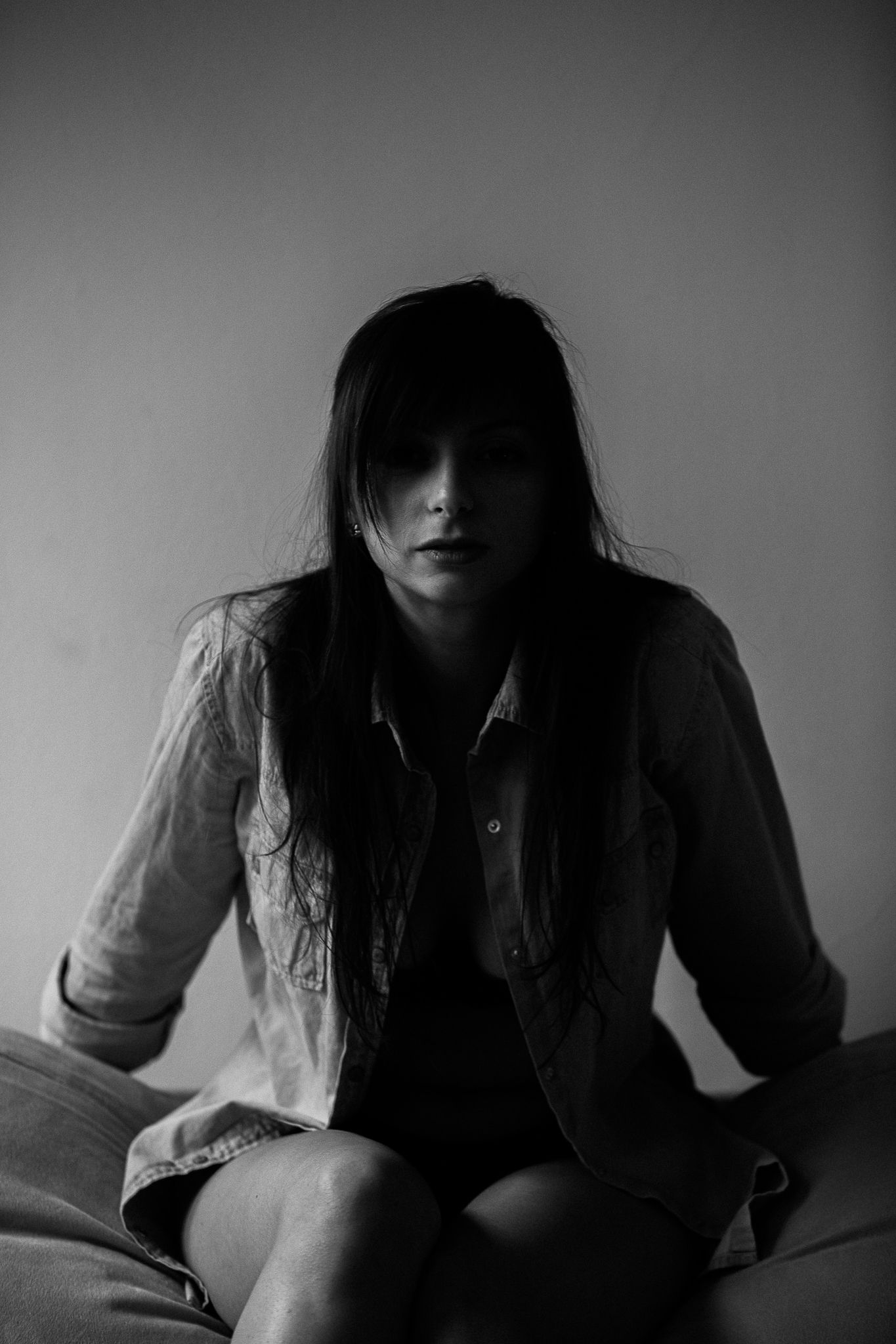 Artistic black and white photo series showing contemplative poses against dark background.
