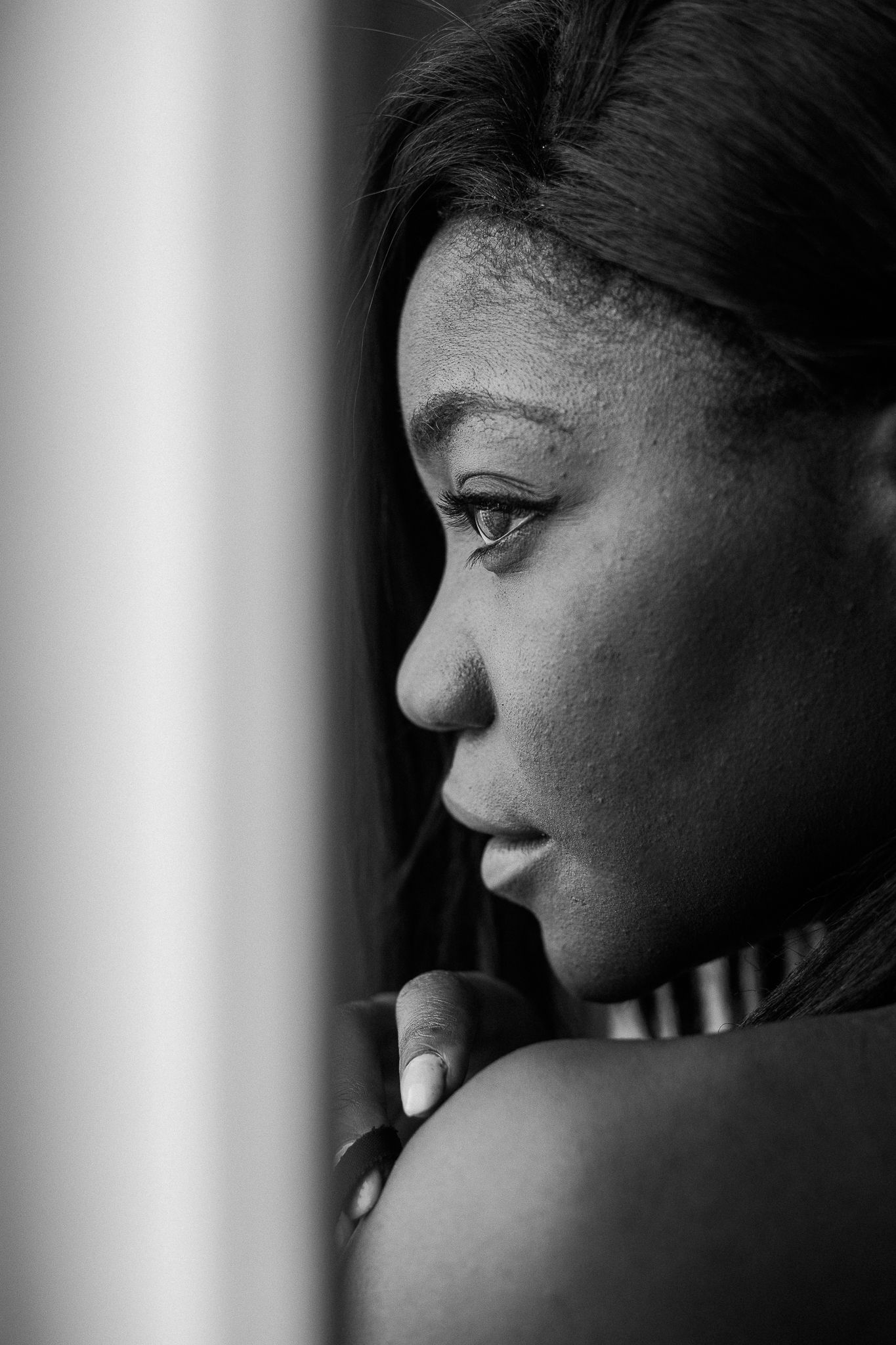 A series of black and white profile portraits showing a contemplative expression in dramatic lighting.