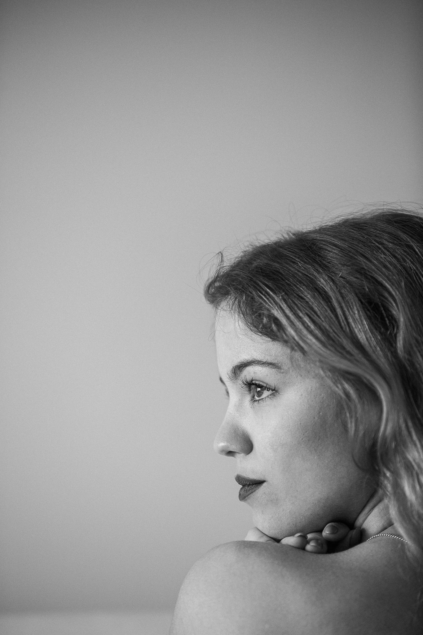 A series of black and white profile portraits showing different angles and expressions in an artistic composition.