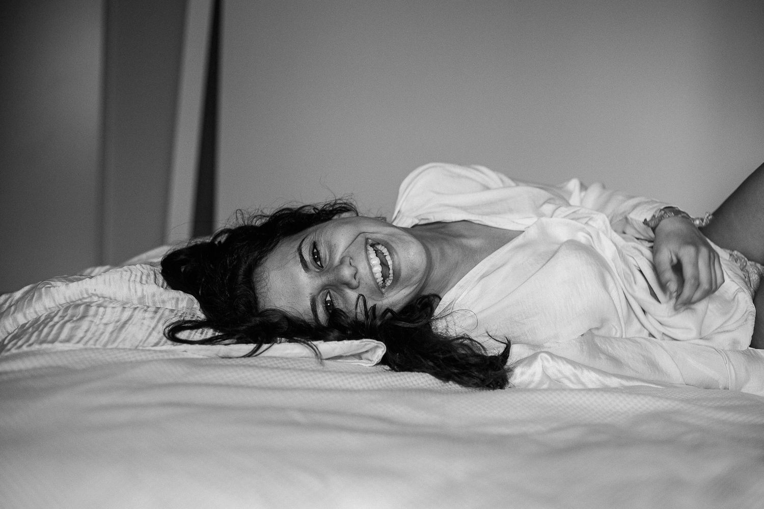 Moody black and white sequence of someone lying on a bed in different poses.