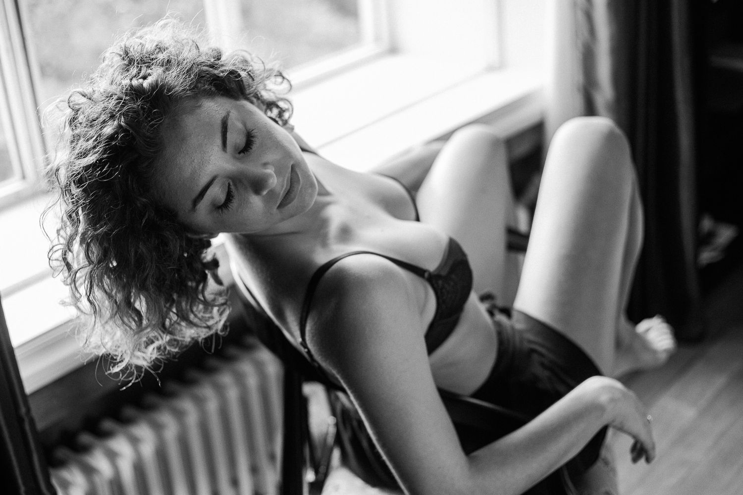 A black and white photo series showing intimate boudoir poses in natural window light.