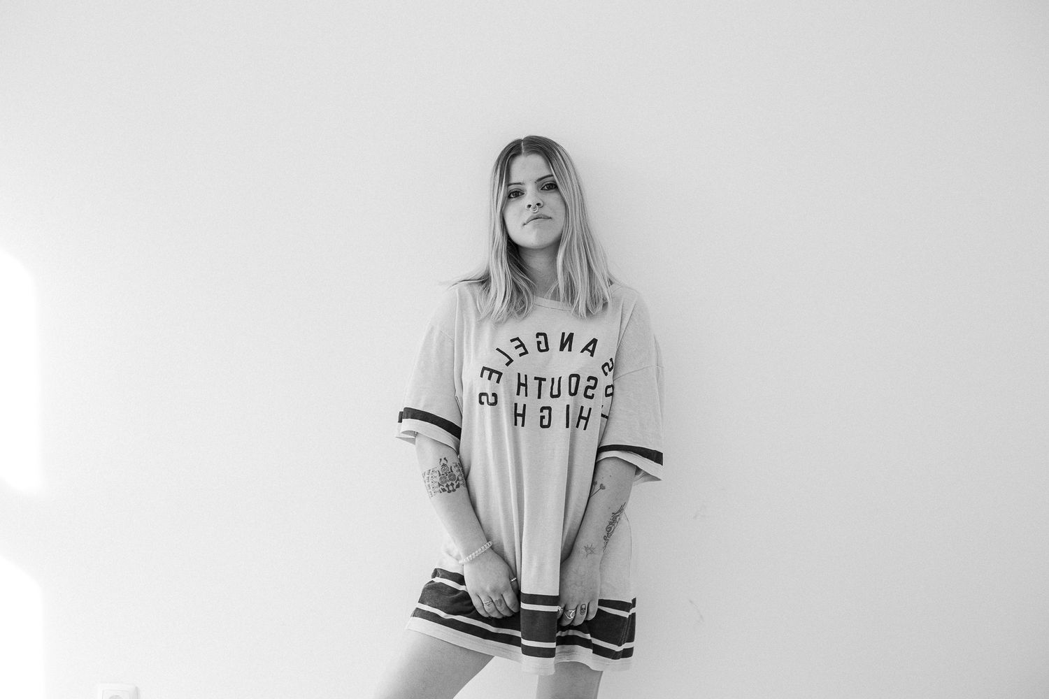 A series of black and white photos showing someone wearing casual athletic wear and loungewear in different poses.