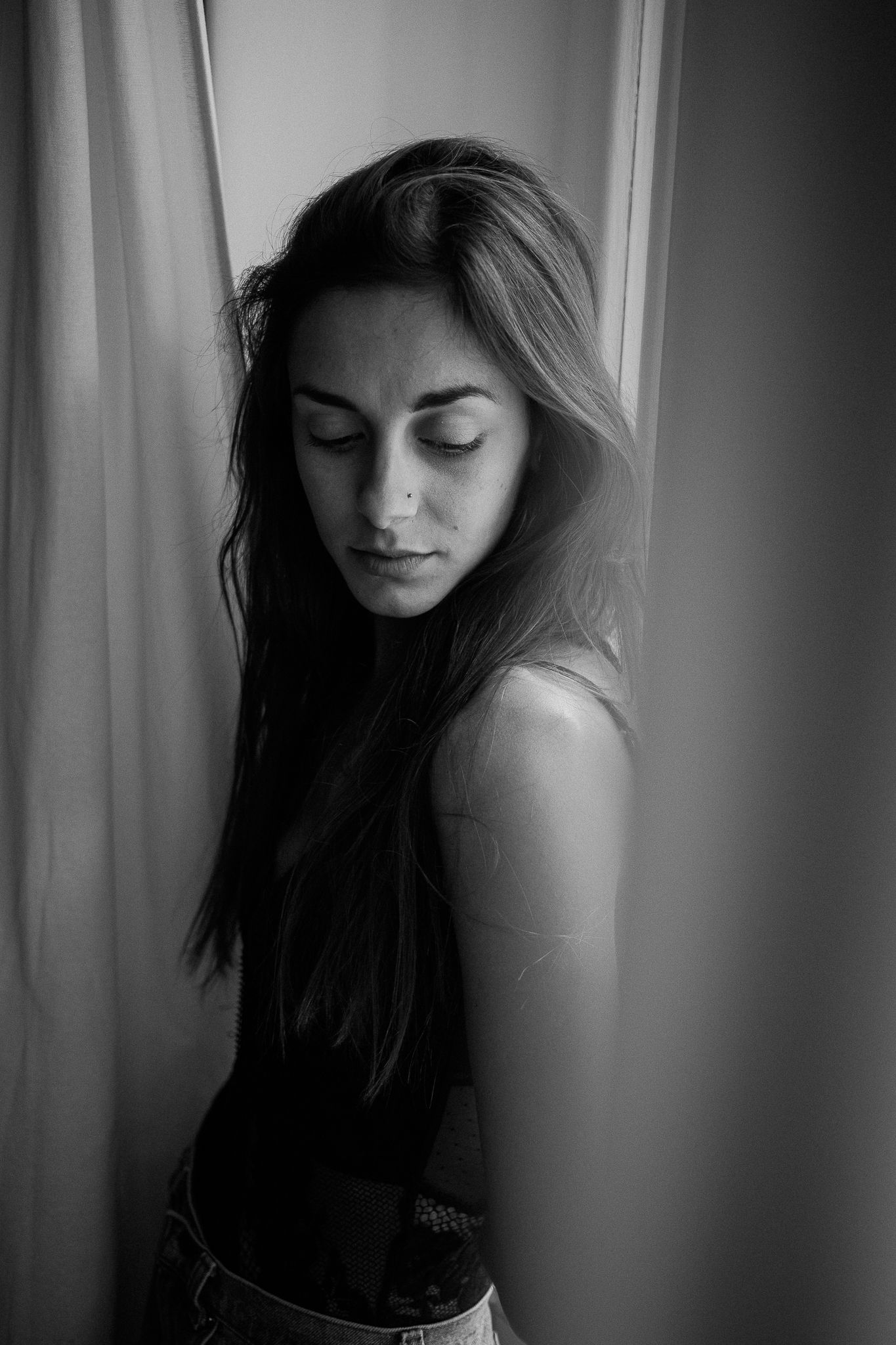 Intimate black and white portrait series with dramatic shadows and lighting.