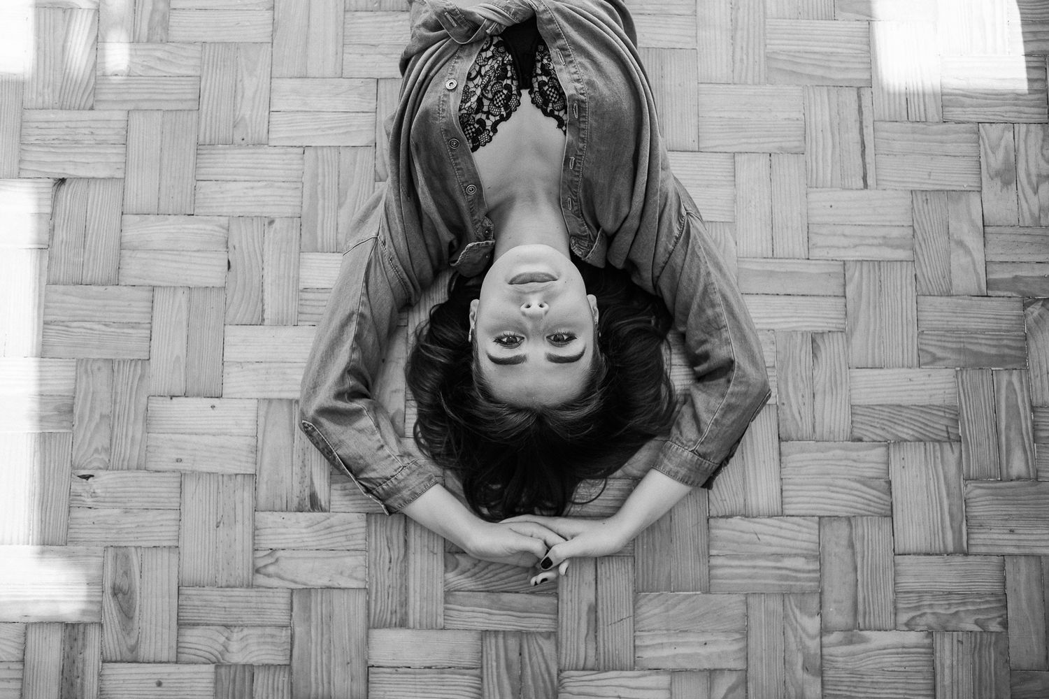 A black and white photo series shows someone performing yoga poses against a textured wall background.