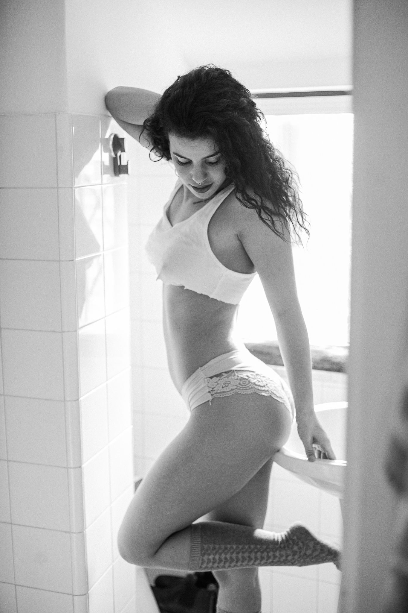 Black and white artistic boudoir photo series showing feminine silhouettes in natural window light.