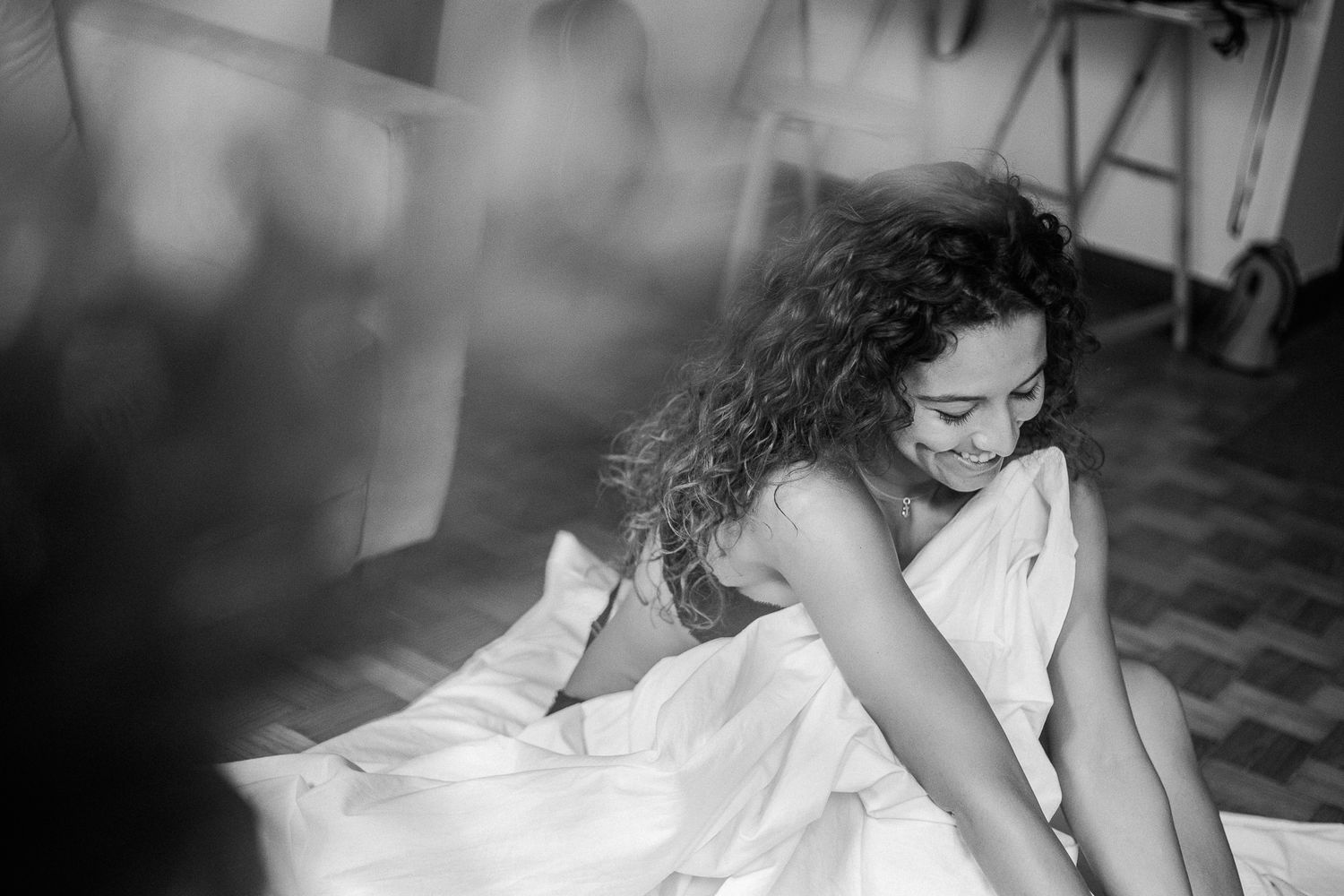 A black and white photo series showing a bride in a flowing wedding dress getting ready for her special day.
