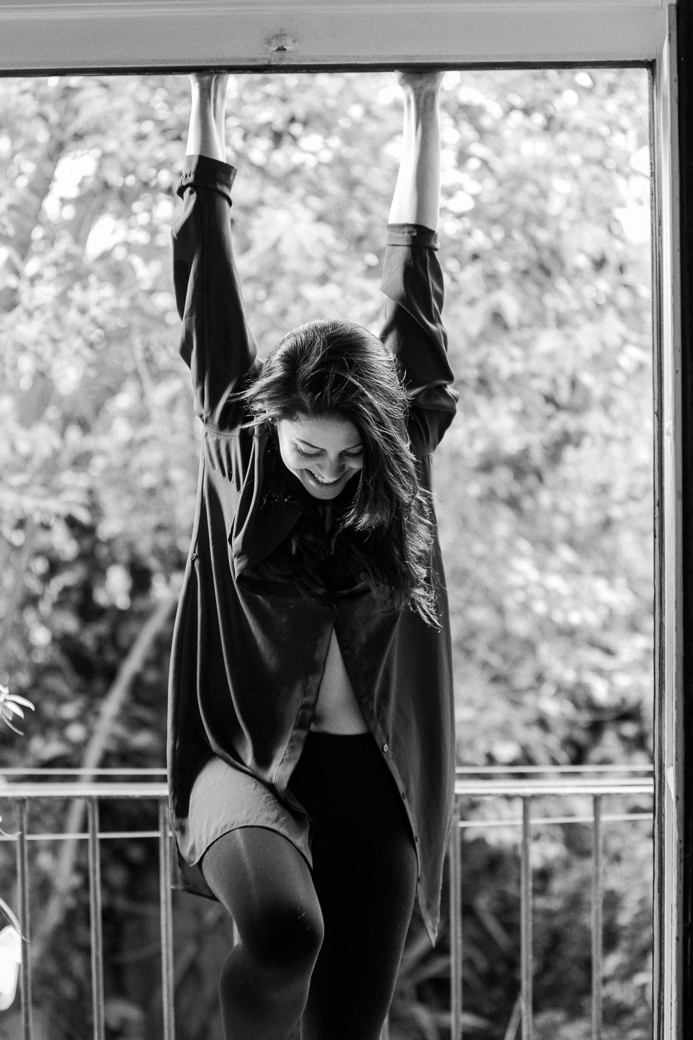 A dancer in black attire performs dynamic movements against a window backdrop in a series of artistic poses.