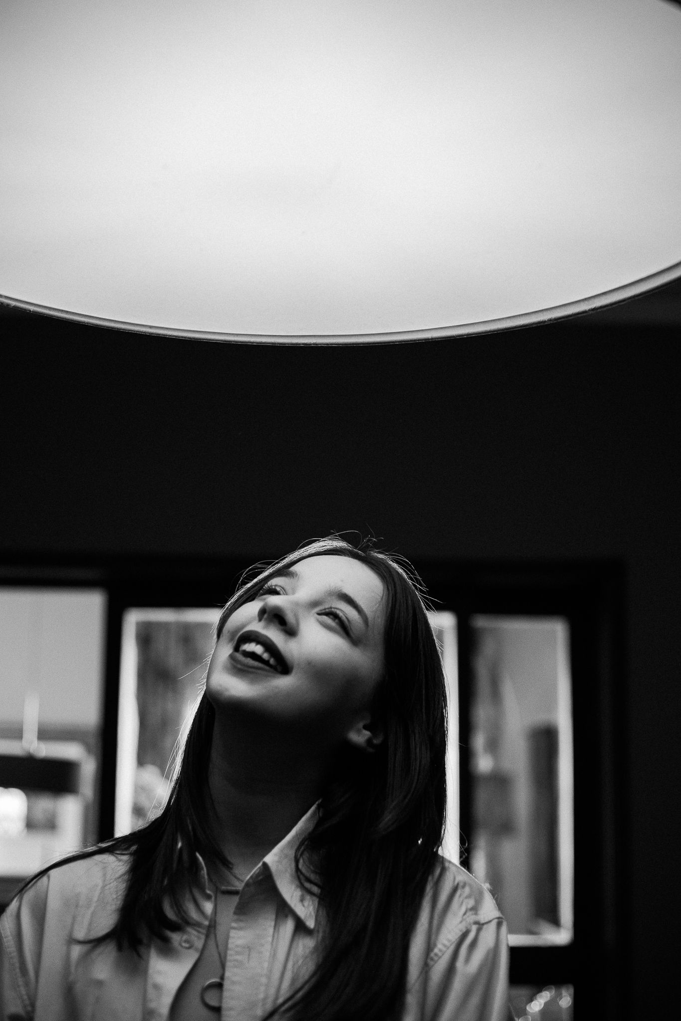 Dramatic black and white portraits with strong contrast and overhead lighting.
