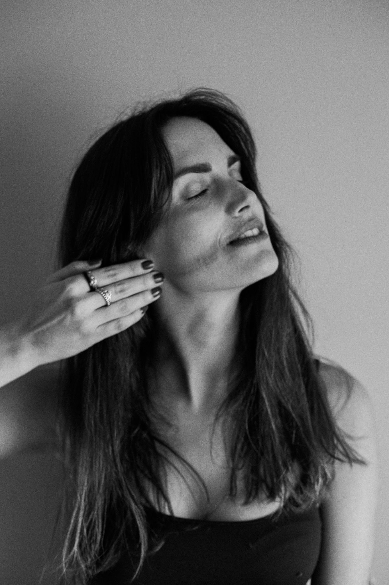 Black and white photo series showing emotional expressions with dramatic head tilts and hand gestures against white background.