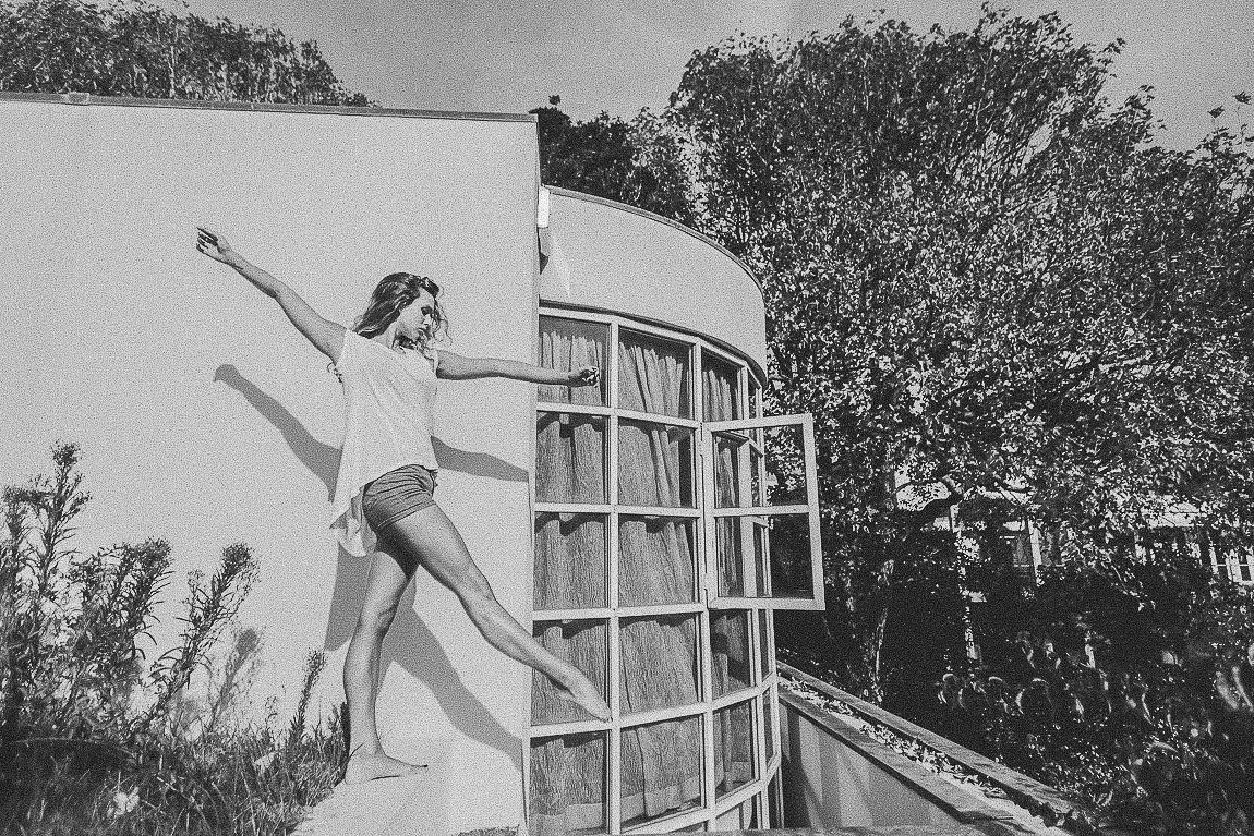 Vintage black and white photo series showing a person performing gymnastic poses and movements on a balcony.