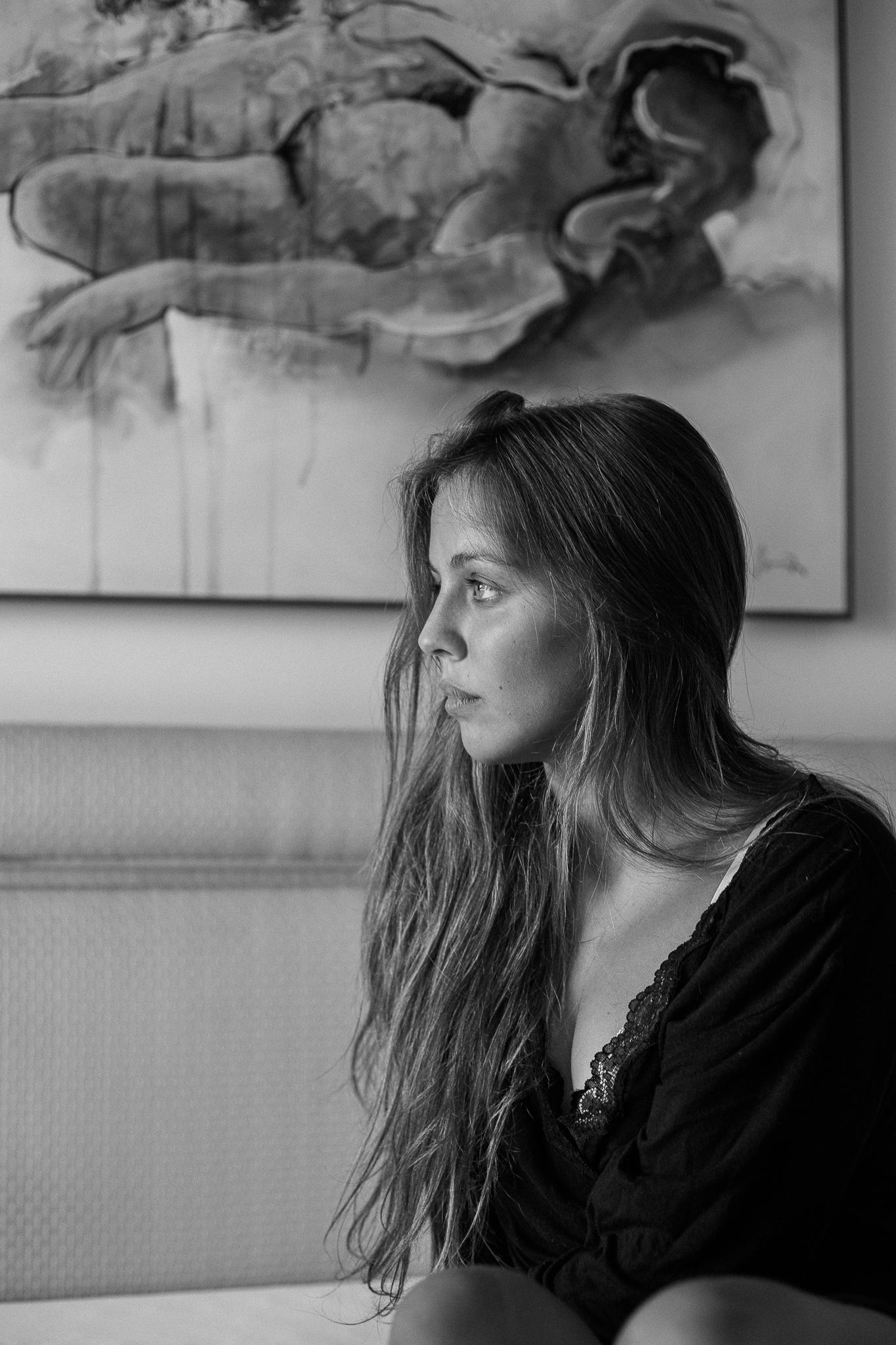 A series of four black and white profile portraits showing hair movement and motion against a light background.