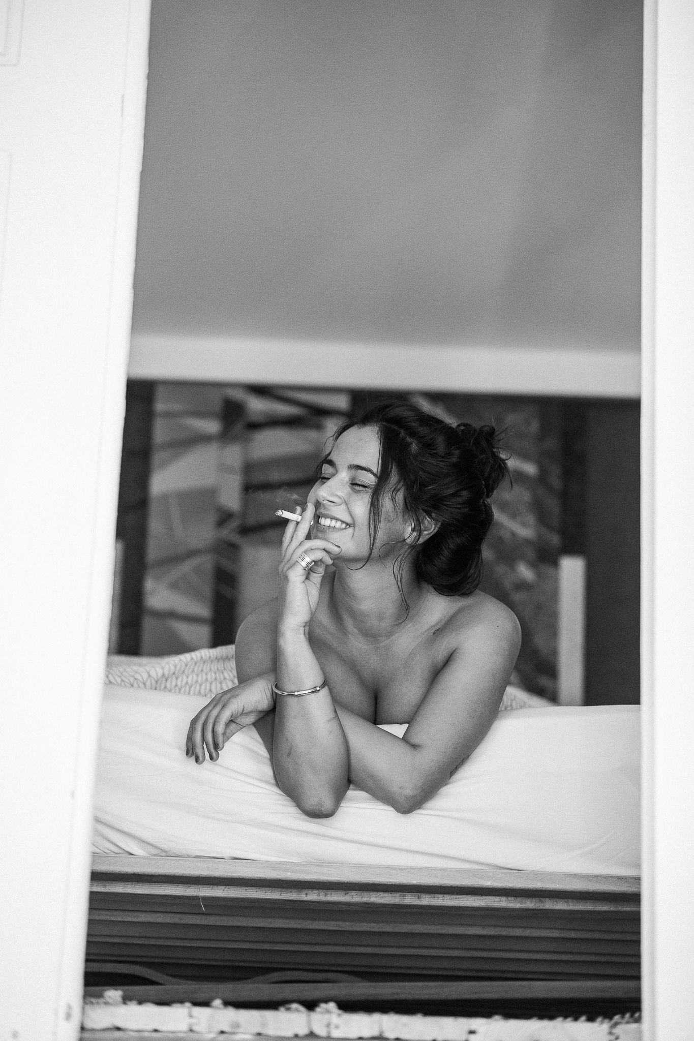 Candid black and white portrait showing joyful laughter while relaxing.
