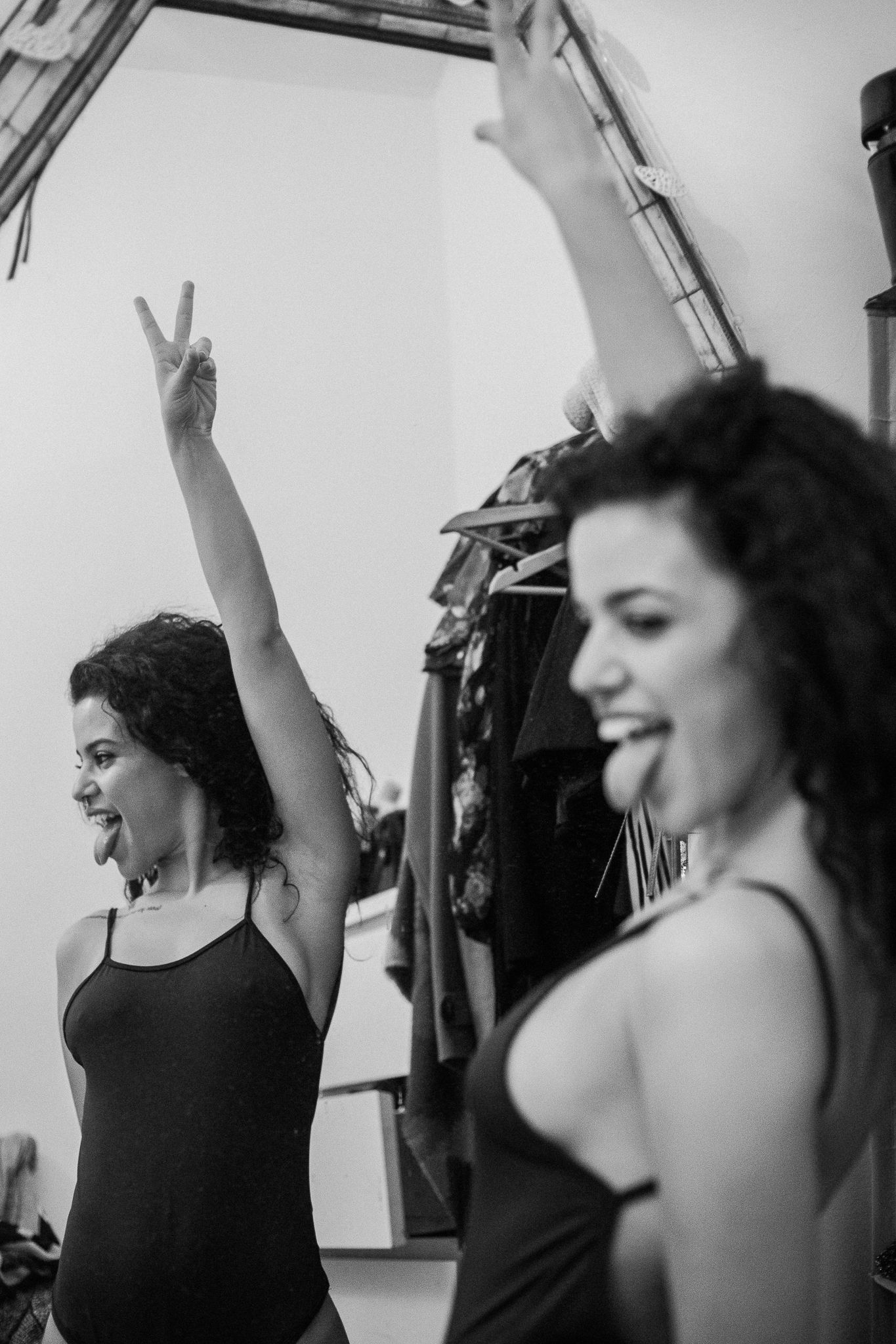 A series of black and white photos showing a dancer in a black tank top moving expressively with flowing hair.