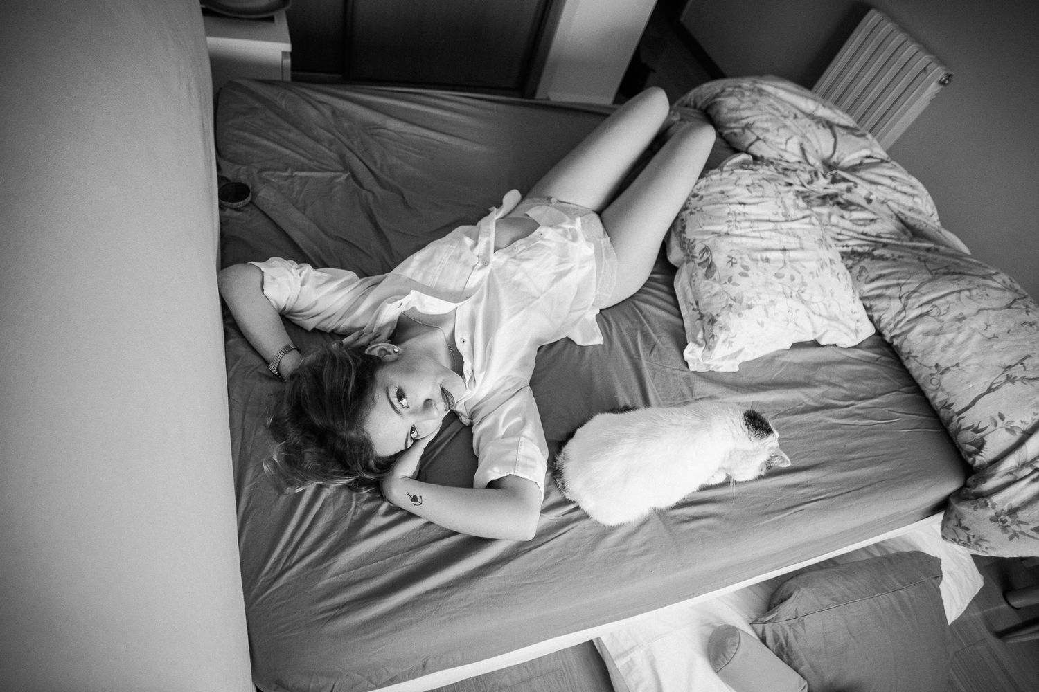A series of black and white photos showing a person tossing and turning in bed while trying to sleep.