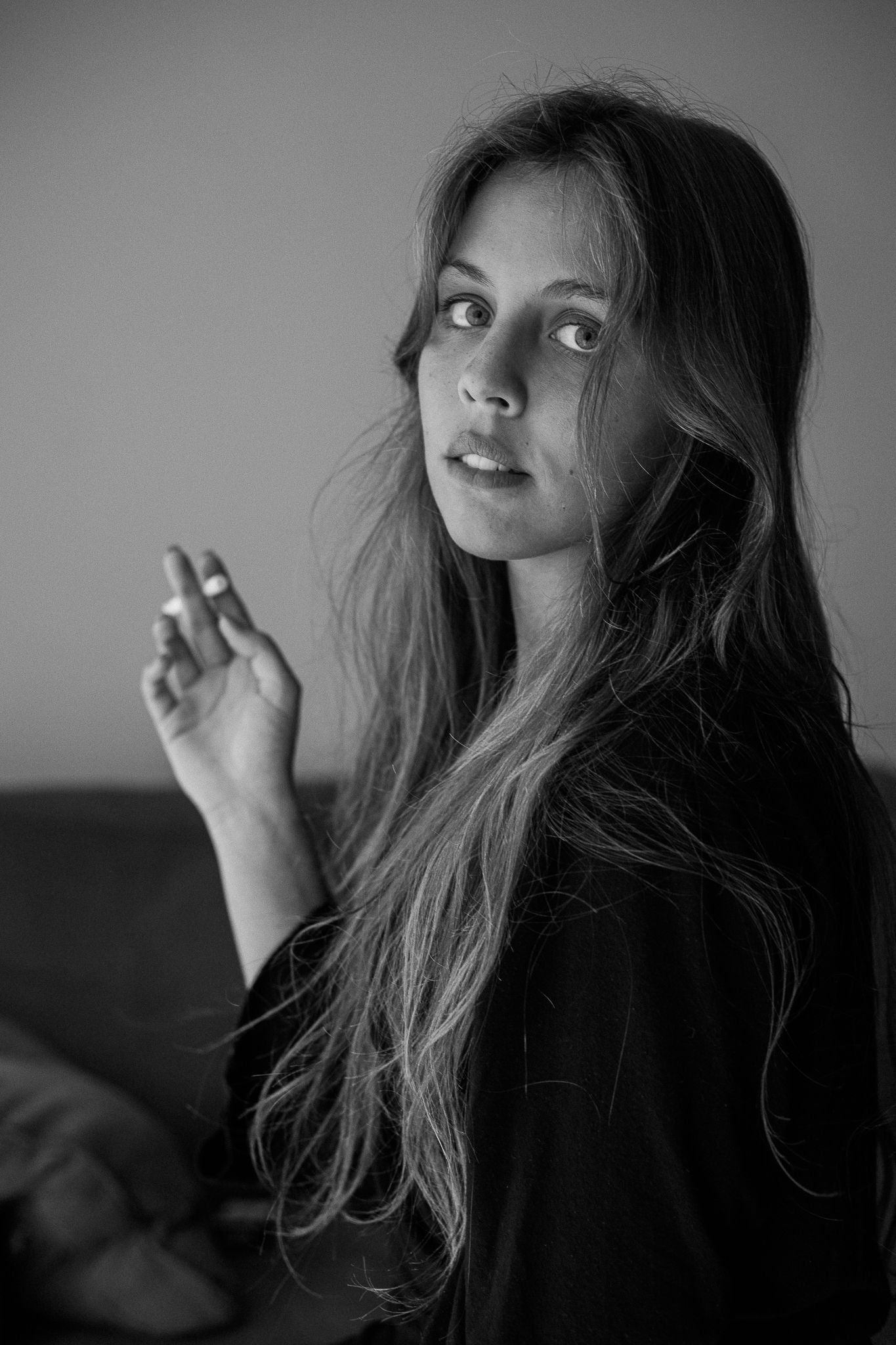 A series of black and white portraits showing long dark hair and dramatic lighting in an artistic style.