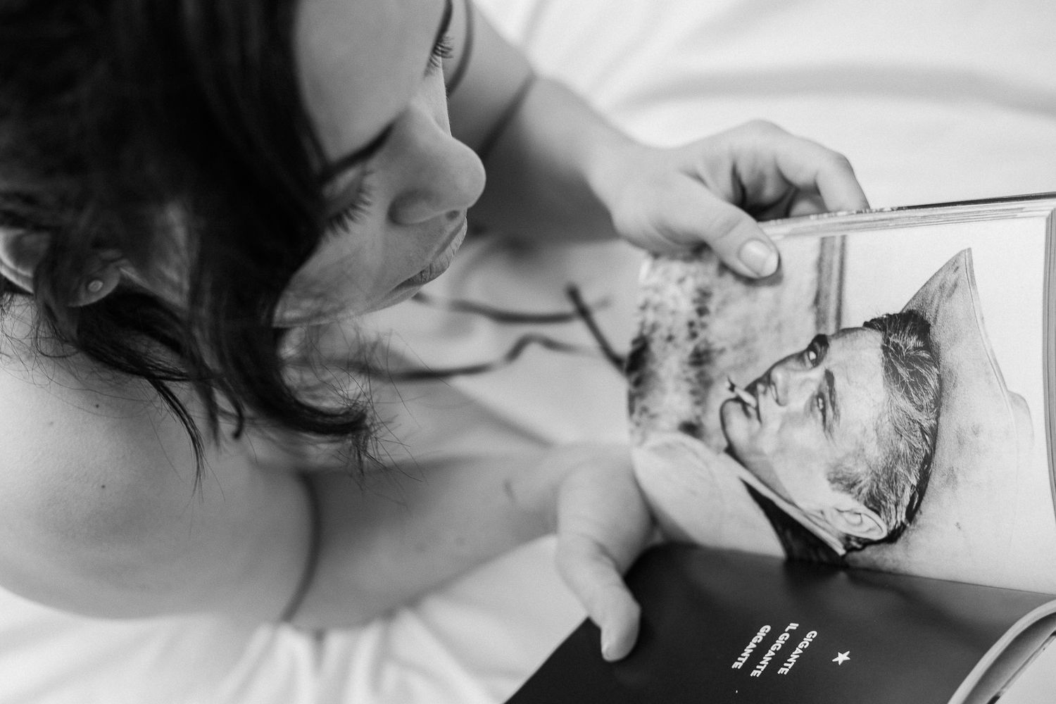 Intimate black and white photographs showing hands and gentle movements in soft light.