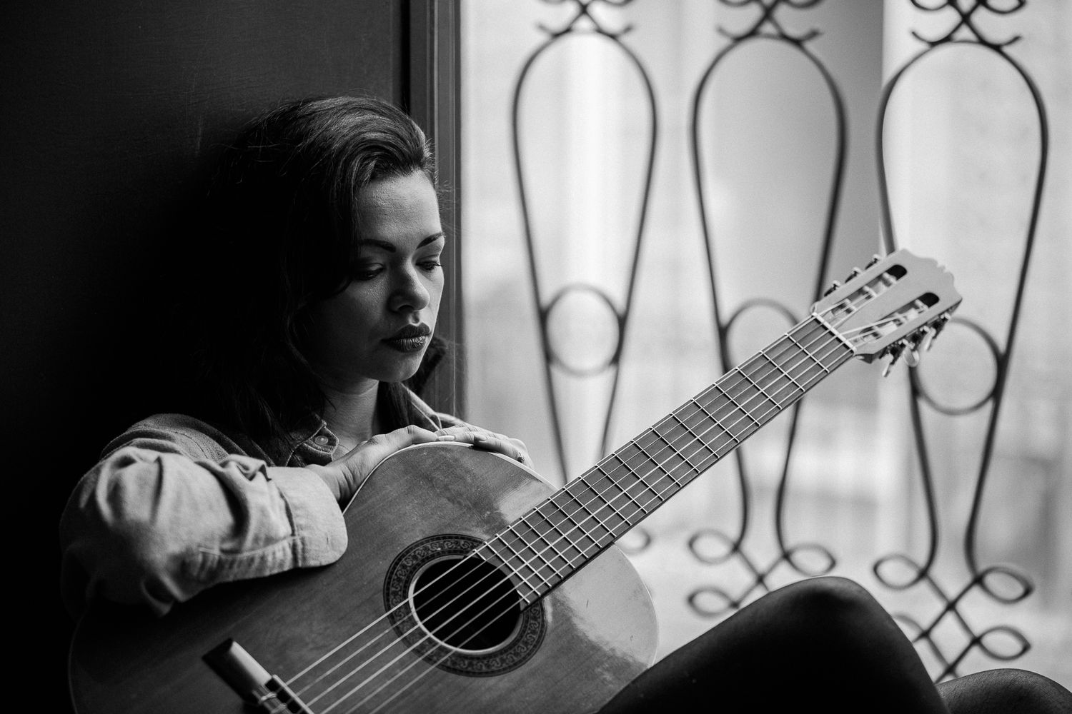 Black and white series featuring a guitar and window light creating artistic shadows.