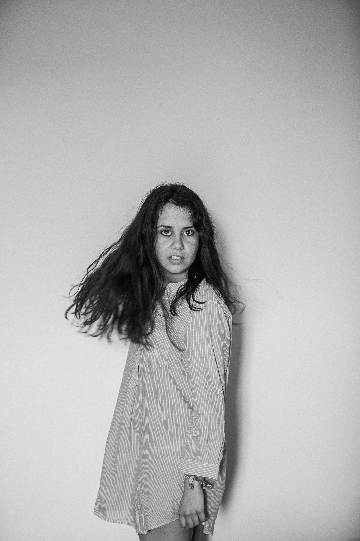 Expressive motion sequence showing hair movement against plain background.