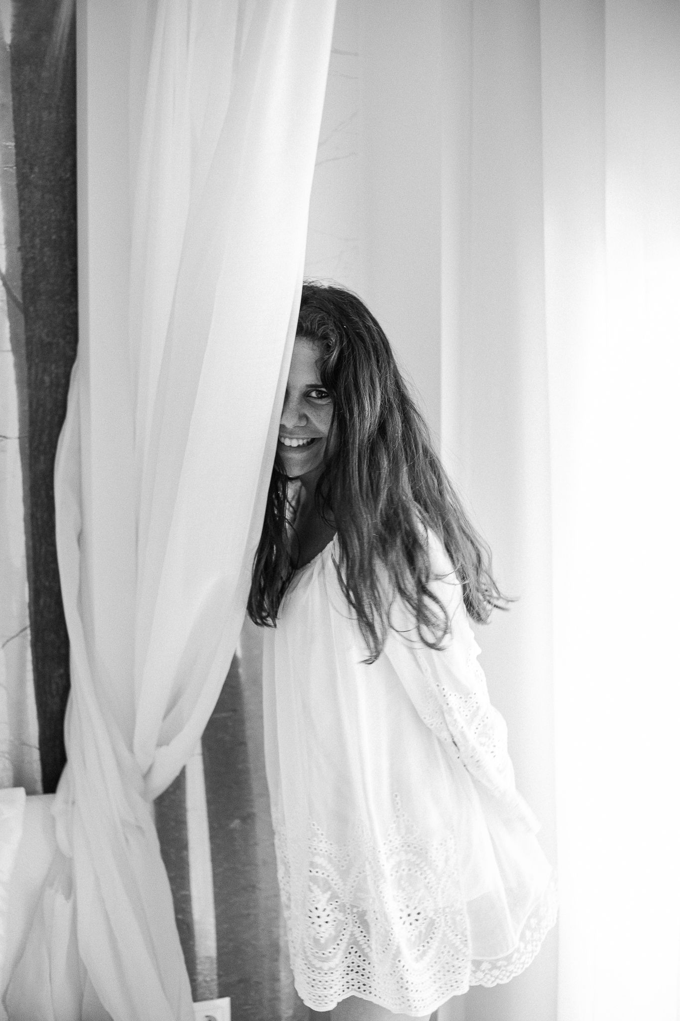 Ethereal portraits showing a figure emerging from behind white lace curtains.