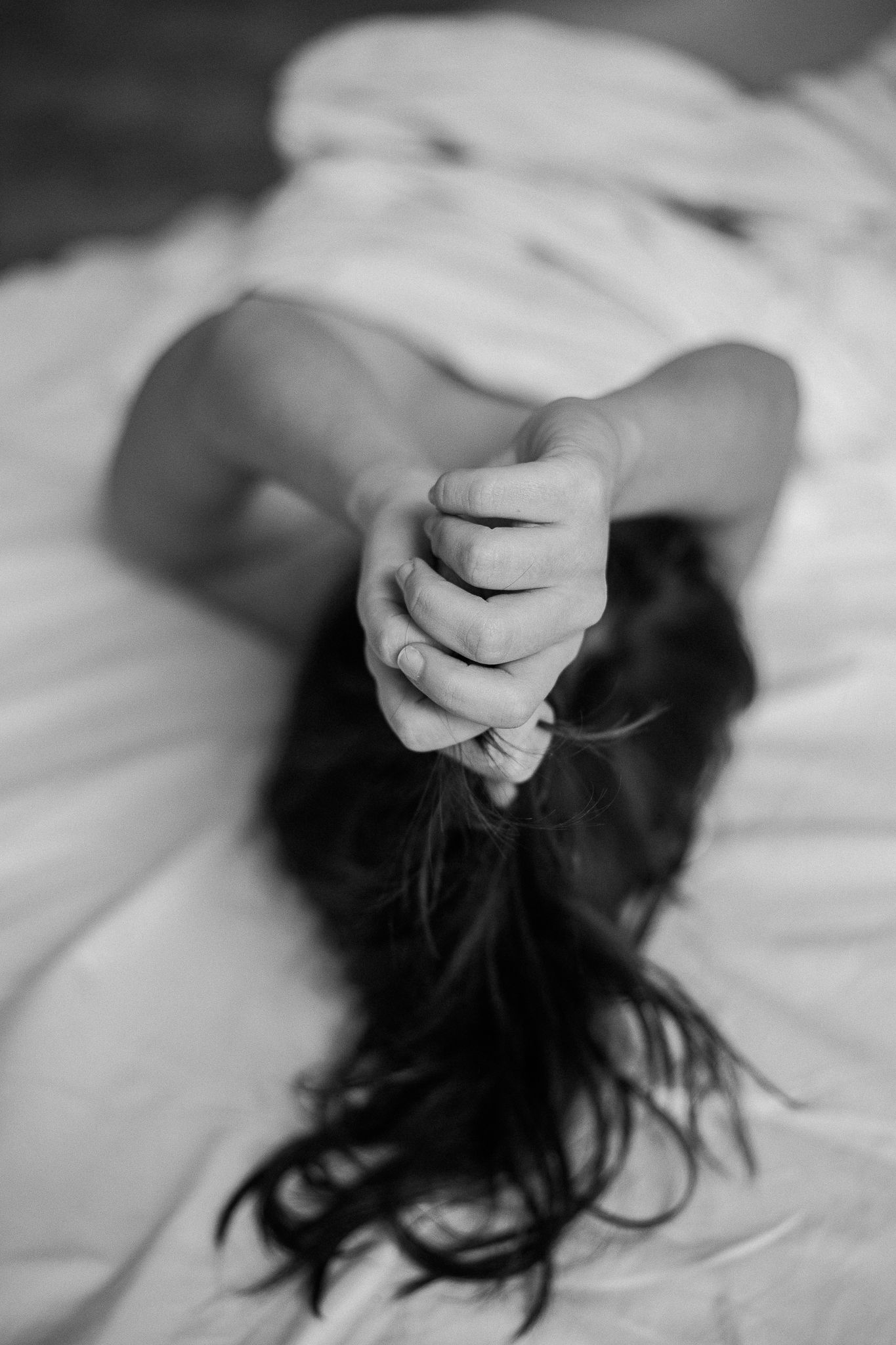 Intimate black and white photography focusing on gentle hand movements.