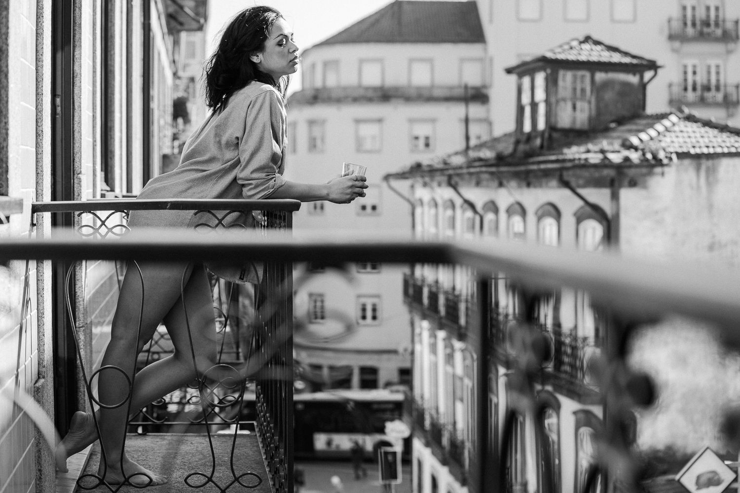 Black and white portrait series showing contemplative moments near a window with dramatic lighting.