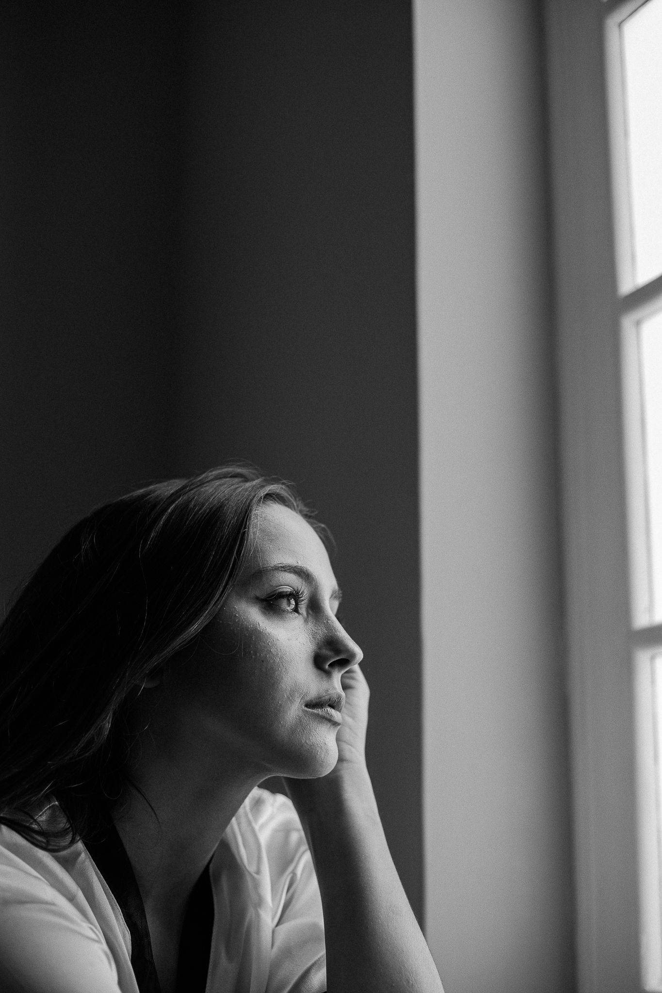 A black and white portrait sequence shows a person looking upward near a window in dramatic lighting.