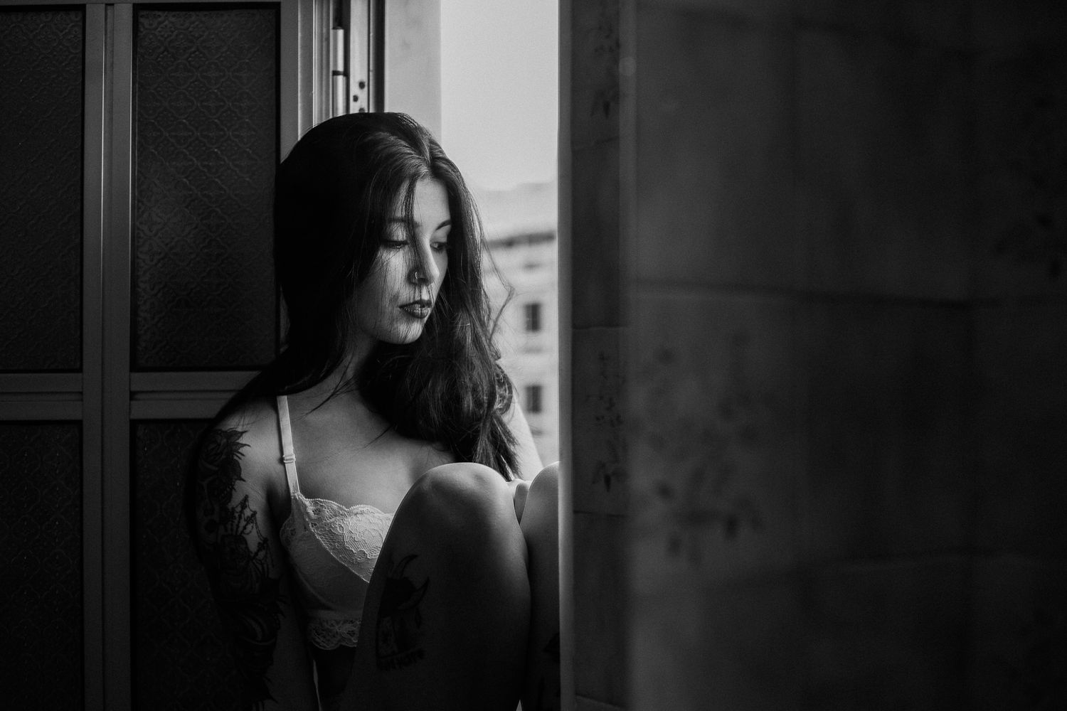 A series of black and white portraits showing a woman with long dark hair in different poses and expressions.