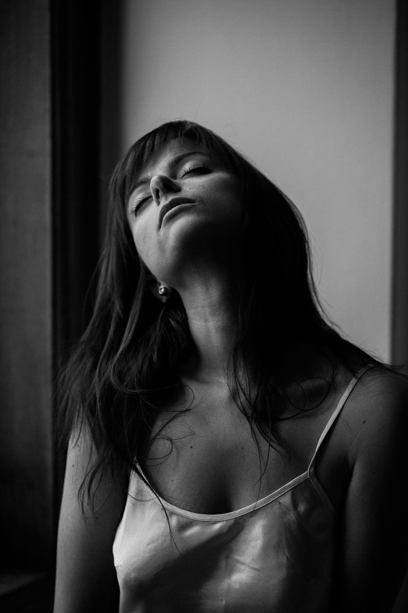 Dramatic black and white portraits with strong shadows and emotional expressions.