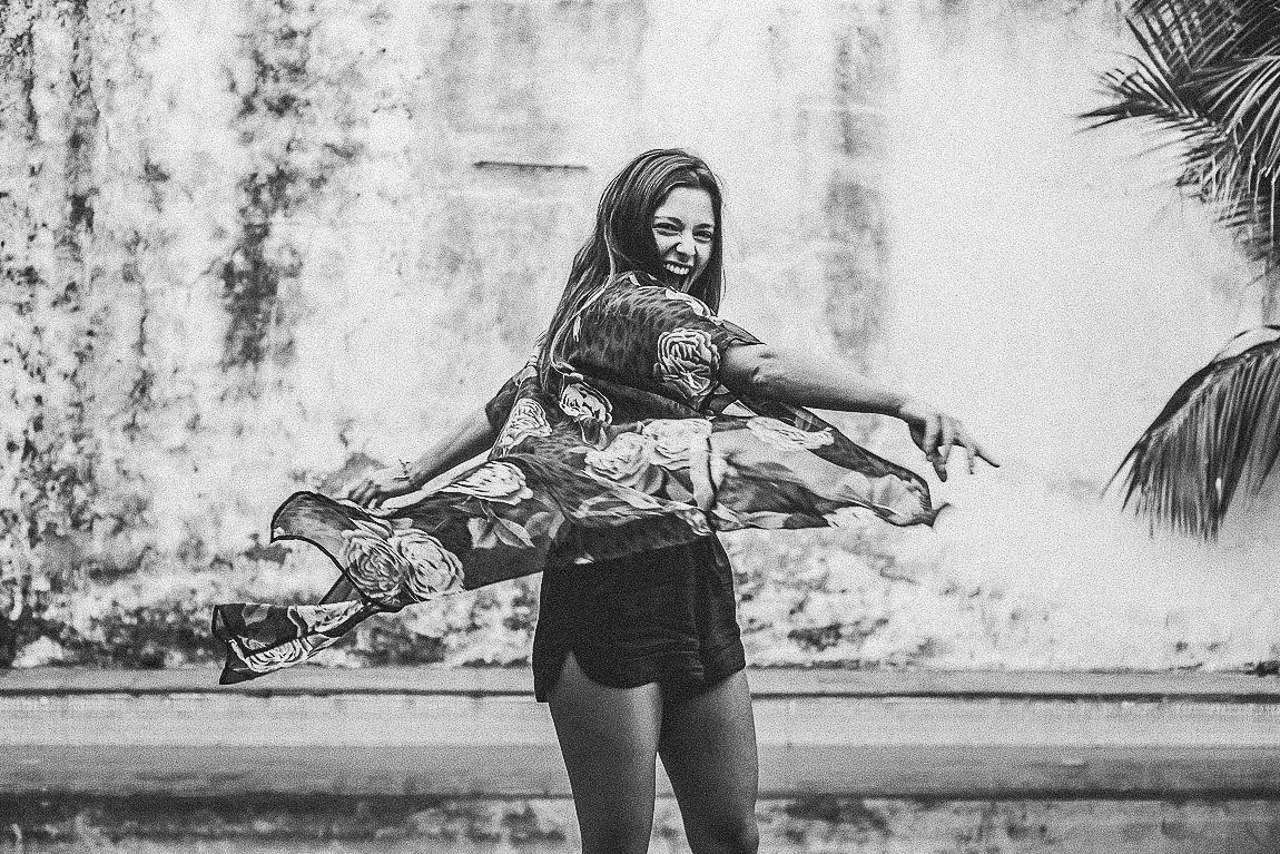 A sequence of monochrome images showing dynamic poses against a weathered wall background.