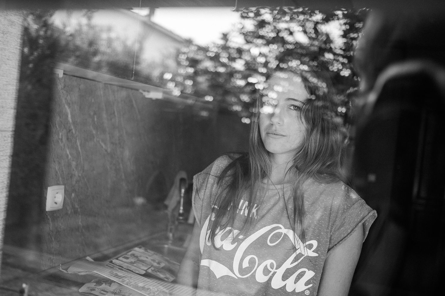 Artistic black and white photo sequence with reflective window elements.