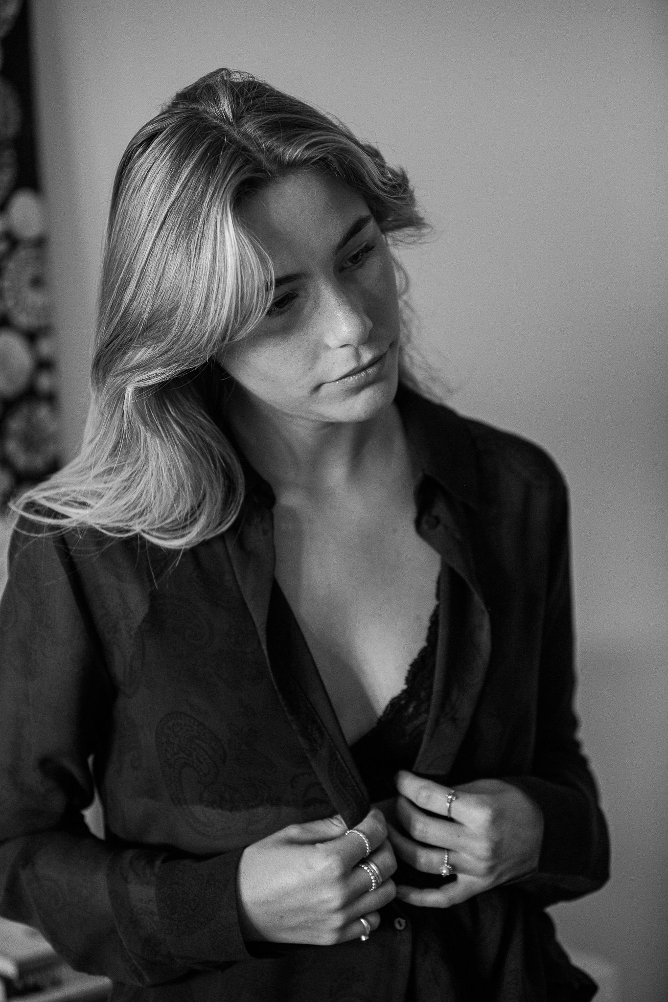 Artistic black and white portrait series showing a person in a black shirt against a light background.